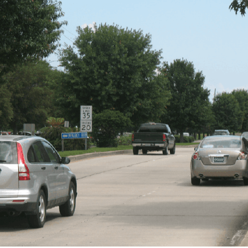 A street view of cars in Kenner