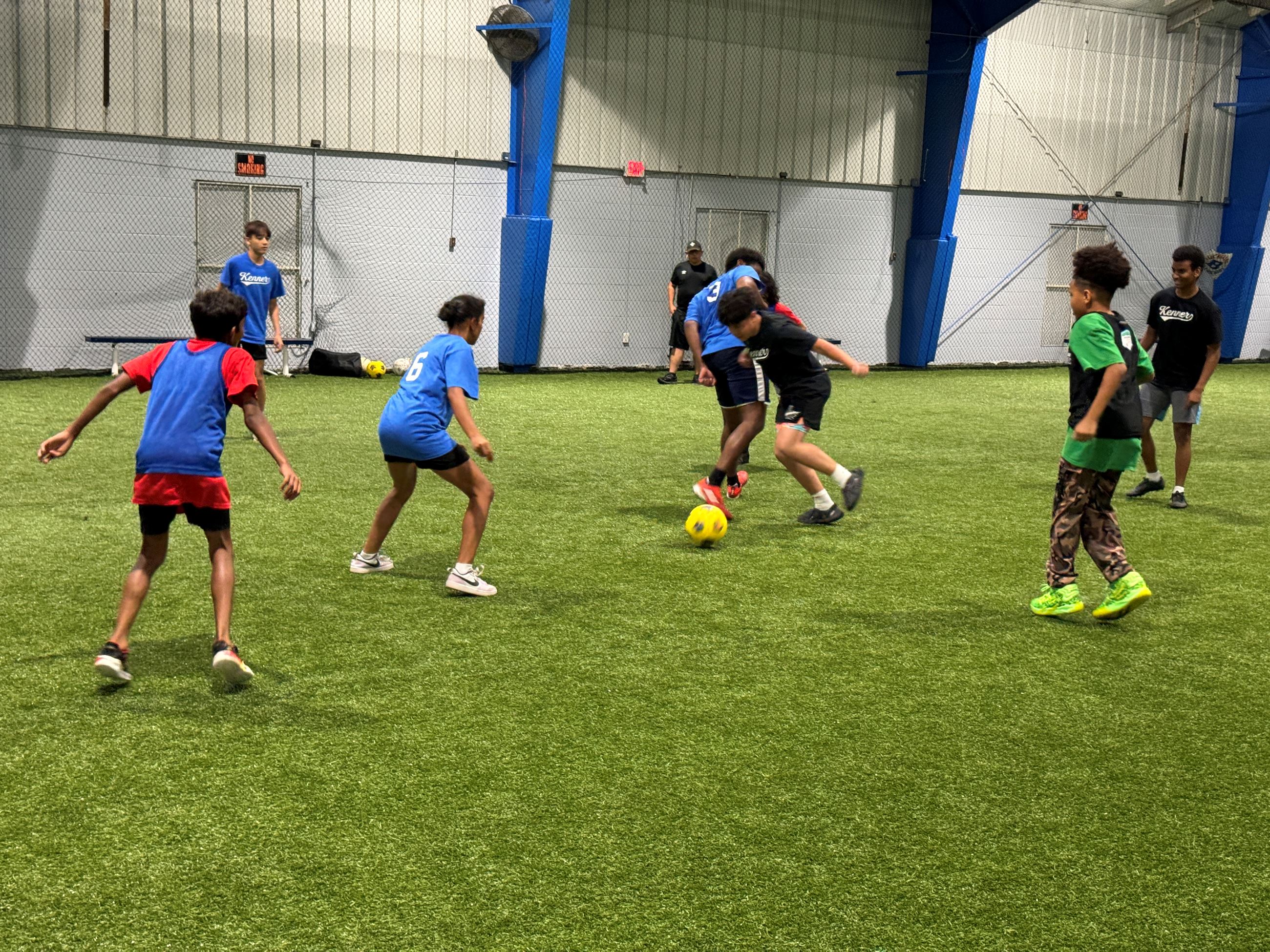 Indoor soccer field with kids playing