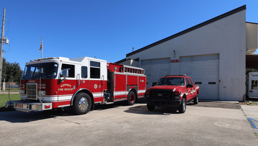 Kenner Fire Station 39 with a red fire truck and for truck in the front of the building 
